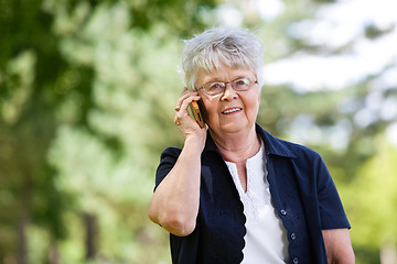 Image showing Senior woman having conversation on mobile phone