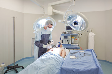 Image showing Young doctor performing operation