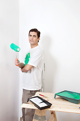 Image showing Man with paint roller