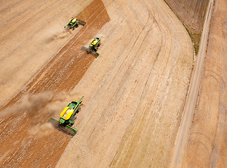 Image showing Three Combines in Grain Field