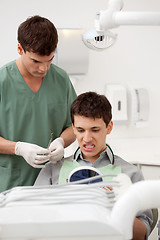Image showing Dentist with Patient Looking at Teeth