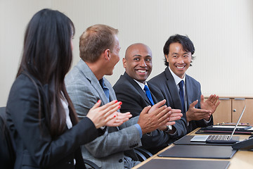 Image showing Professionals applauding during a business meeting