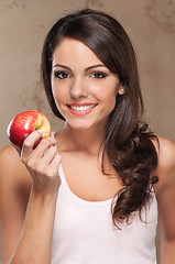 Image showing Smiling woman holding apple