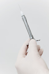 Image showing Close-up of hand holding needle