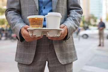 Image showing Businessman holding takeaway coffee cups