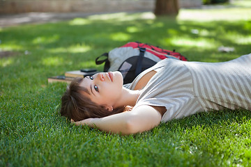 Image showing Girl lying down at college campus