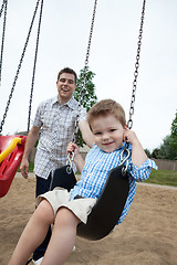 Image showing Father Pushing Son on Swing