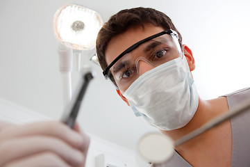 Image showing Dentist holding dental tool
