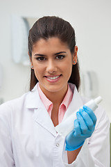 Image showing Female dentist holding toothpaste