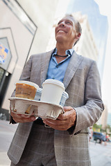 Image showing Businessman carrying takeaway cups