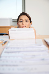 Image showing Businesswoman Behind Pile Of Paper