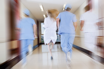 Image showing Doctor and nurse running in passageway