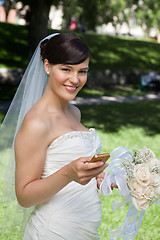 Image showing Newlywed Bride Holding Cell Phone