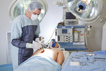 Image showing Male doctor performing operation