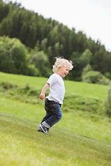 Image showing Toddler Boy Walking Alone in Garden