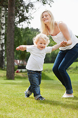 Image showing Baby boy learning to walk