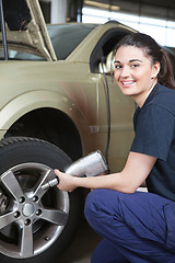 Image showing Happy Woman Mechanic Tire Change