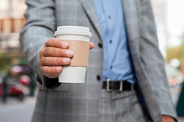 Image showing Businessman holding disposable cup