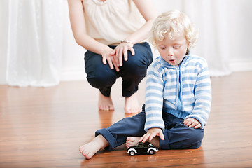 Image showing Cute boy playing with toy car