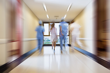 Image showing Surgeon and nurse running in passageway