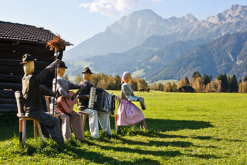 Image showing Group of scarecrows in female dress standing on a field