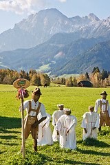 Image showing Group of scarecrows in female dress standing on a field