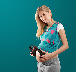 Image showing pregnant female with headphones