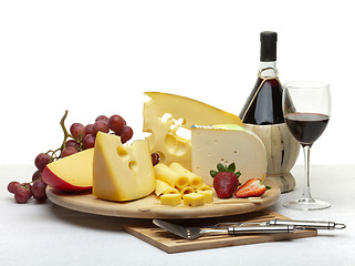 Image showing Cheese still life on a wooden round tray