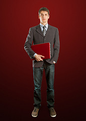 Image showing male in suit with laptop in his hands