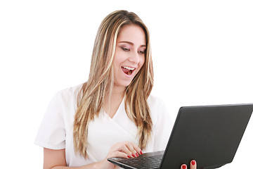 Image showing A woman doctor is surprised and looking at her laptop. 