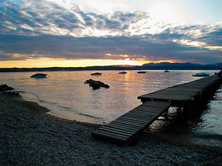 Image showing Sunset over Lago di Garda, Italy with Boats and Dock