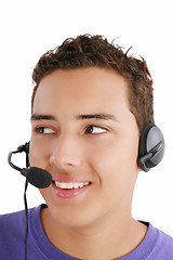 Image showing Smiling businessman talking on headset against a white backgroun