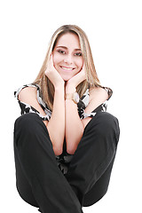 Image showing Smiling sexy blond woman sitting on a floor isolated on white 