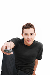 Image showing Teenage boy with TV remote control