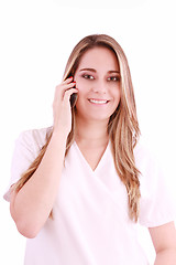 Image showing Young beautiful woman-nurse talks by mobile phone, isolated on w