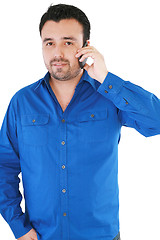 Image showing young casual man talking on the phone isolated on white backgrou