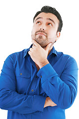 Image showing Young man in thoughtful pose. Isolated over white. 