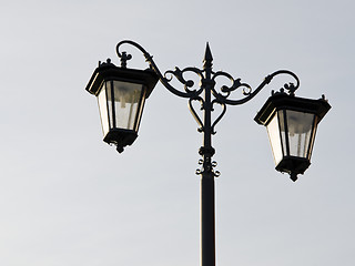 Image showing Old town street illuminator. Lamps hanging on pole