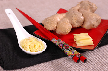 Image showing Hand of ginger with minced and sliced ginger