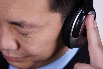 Image showing Asian businessman listening