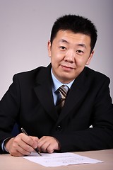 Image showing Asian Businessman Writting