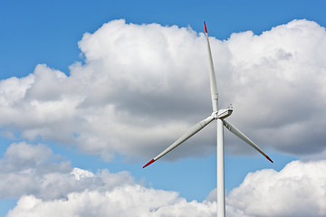 Image showing Wind power station against the blue sky with clouds