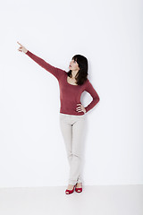 Image showing Beautiful woman standing and pointing