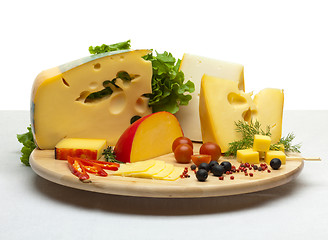 Image showing Cheese still life on a wooden round tray