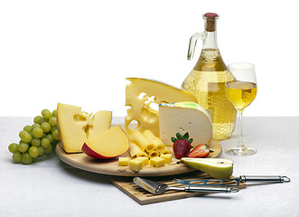 Image showing Cheese still life on a wooden round tray