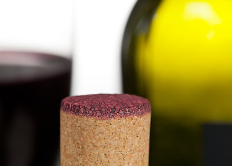 Image showing Red wine soaked cork in front of glass