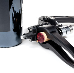 Image showing Red wine soaked cork in modern corkscrew