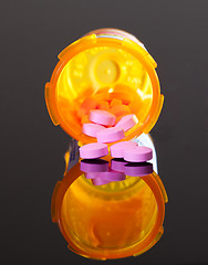 Image showing Purple pills from orange drug bottle