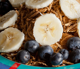 Image showing Slices of banana and blueberries on cereal