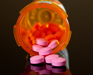 Image showing Purple pills from orange drug bottle